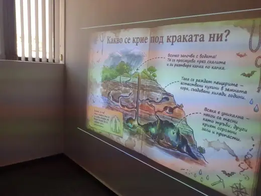 Проектиран слайд „Какво се крие под краката ни?“ с разрез на почвата и пещера